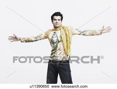 Stock Image - Portrait of a young man with his arms outstretched. Fotosearch