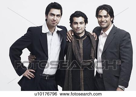 Stock Photograph - Portrait of three young men standing with their arms around each other. Fotosearch