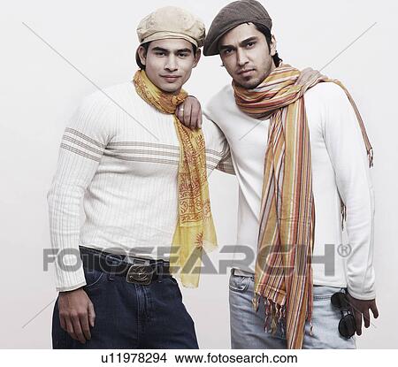 Picture - Portrait of two young men with their arms around each other. Fotosearch