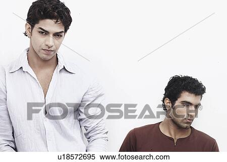 Stock Photography - Two young men looking serious. Fotosearch
