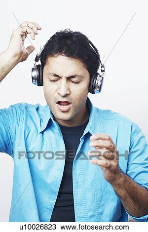 Young man listening to music with his eyes closed View Large Photo Image Stock Image - Young man listening to music with his eyes closed. Fotosearch