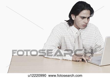 Stock Image - Close-up of a businessman using a laptop. Fotosearch