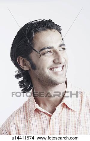 Close-up of a young man smiling View Large Photo Image Picture - Close-up of a young man smiling. Fotosearch