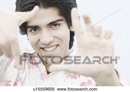 Portrait of a young man gesturing View Large Photo Image Stock Photography - Portrait of a young man gesturing. Fotosearch