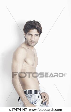 Portrait of a young man standing bare chested View Large Photo Image Stock Photo - Portrait of a young man standing bare chested. Fotosearch