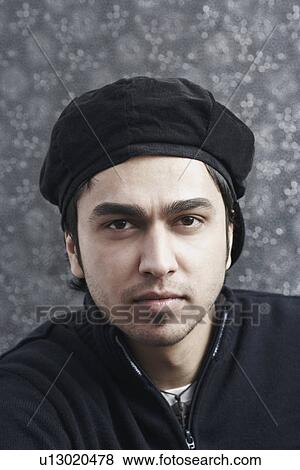 Portrait of a young man wearing a cap View Large Photo Image Stock Photo - Portrait of a young man wearing a cap. Fotosearch