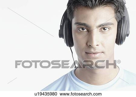 Stock Image - Portrait of a young man wearing headphones. Fotosearch