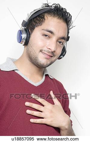 Portrait of a young man wearing headphones View Large Photo Image Stock Photography - Portrait of a young man wearing headphones. Fotosearch