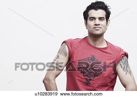 Portrait of a young man with tattoos on his arms View Large Photo Image Stock Photo - Portrait of a young man with tattoos on his arms. Fotosearch