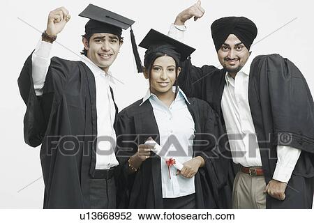 Stock Image - Portrait of two young men and a young woman in graduation gowns. Fotosearch