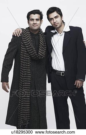 Portrait of two young men standing with their arms around each other View Large Photo Image Stock Image - Portrait of two young men standing with their arms around each other. Fotosearch