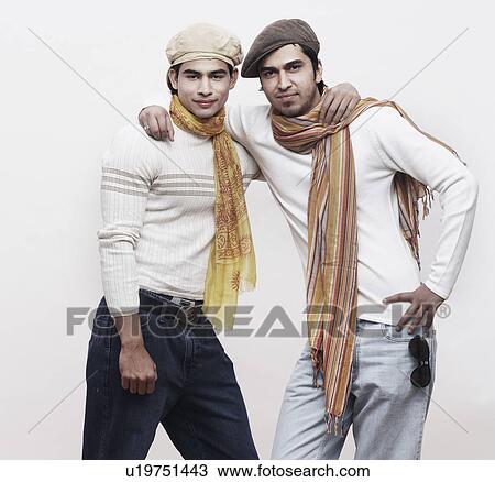 Stock Image - Portrait of two young men with their arms around each other. Fotosearch