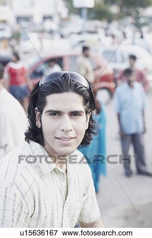 Stock Photo - Side profile of a young man wearing sunglasses. Fotosearch