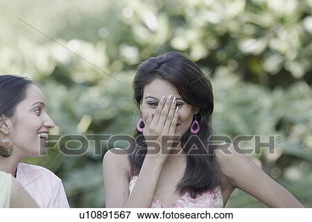 Close-up of a young woman and a teenage girl smiling View Large Photo Image Stock Photo - Close-up of a young woman and a teenage girl smiling. Fotosearch
