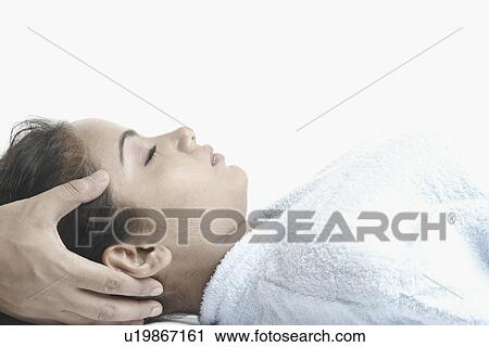Close-up of a young woman getting a head massage View Large Photo Image Stock Image - Close-up of a young woman getting a head massage. Fotosearch