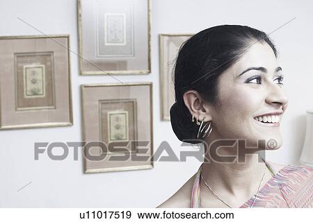 Close-up of a young woman smiling View Large Photo Image Stock Photo - Close-up of a young woman smiling. Fotosearch