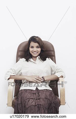 Stock Photo - Portrait of a businesswoman sitting on an office chair. Fotosearch