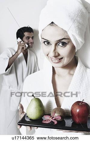 Portrait of a young woman holding a tray of fruit View Large Photo Image Stock Photography - Portrait of a young woman holding a tray of fruit. Fotosearch
