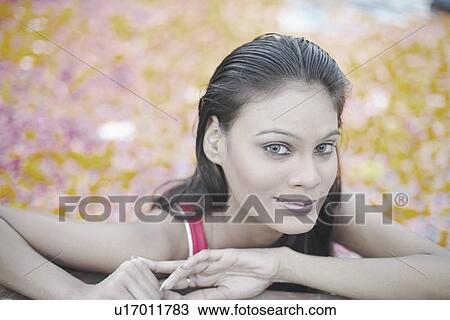 Stock Image - Portrait of a young woman smiling. Fotosearch