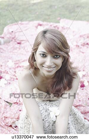 Portrait of a young woman smiling View Large Photo Image Stock Photo - Portrait of a young woman smiling. Fotosearch