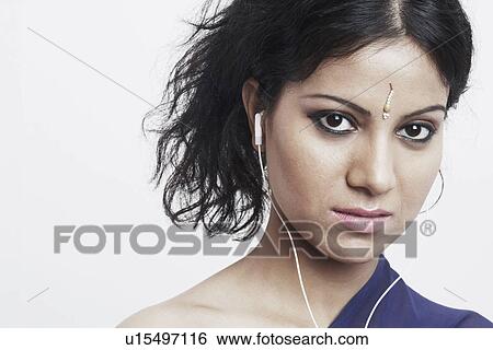 Portrait of a young woman wearing headphones View Large Photo Image Stock Photograph - Portrait of a young woman wearing headphones. Fotosearch