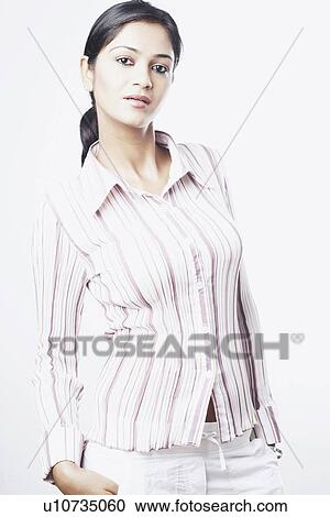 Portrait of a young woman with her hand in her pocket View Large Photo Image Stock Image - Portrait of a young woman with her hand in her pocket. Fotosearch
