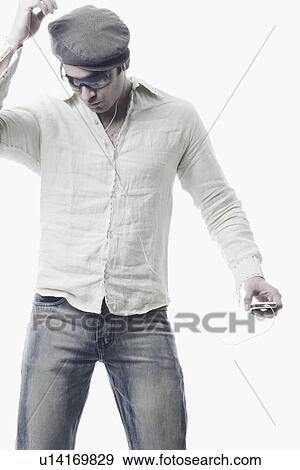Stock Photo - Close-up of a young man listening to an MP3 player. Fotosearch