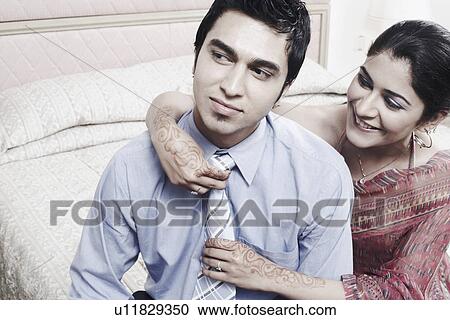 Close-up of a young woman adjusting a young man's tie View Large Photo Image Stock Image - Close-up of a young woman adjusting a young man's tie. Fotosearch