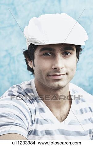 Picture - Portrait of a young man wearing a cap. Fotosearch