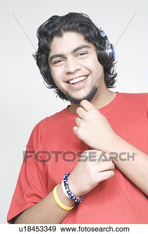 Stock Photo - Portrait of a young man wearing headphones. Fotosearch