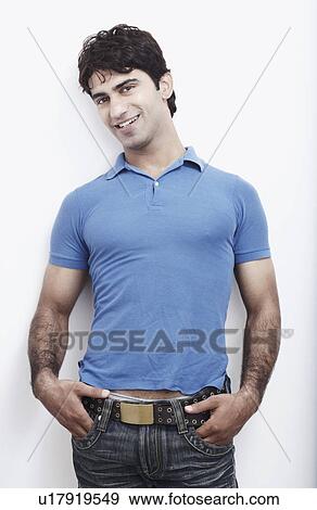 Portrait of a young man with his hands in his pocket View Large Photo Image Stock Photo - Portrait of a young man with his hands in his pocket. Fotosearch