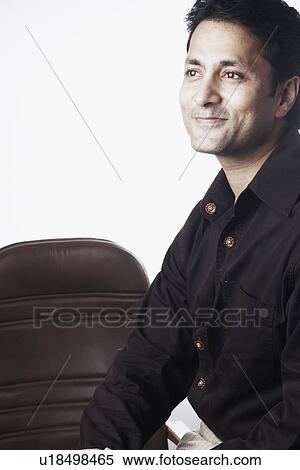 Side profile of a businessman smiling View Large Photo Image Stock Photography - Side profile of a businessman smiling. Fotosearch