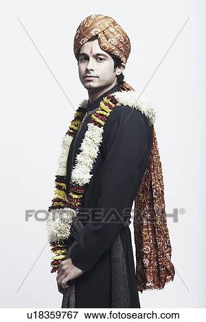 Side profile of a young man wearing a traditional wedding outfit View Large Photo Image Stock Photo - Side profile of a young man wearing a traditional wedding outfit. Fotosearch