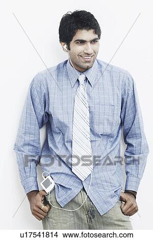 Young man wearing headphones and smiling View Large Photo Image Picture - Young man wearing headphones and smiling. Fotosearch