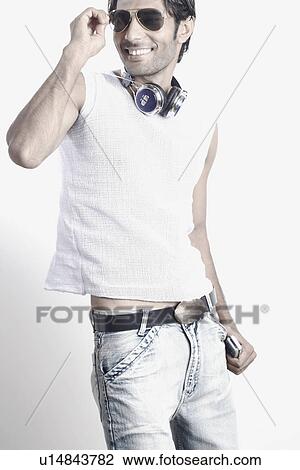 Stock Image - Young man wearing sunglasses. Fotosearch