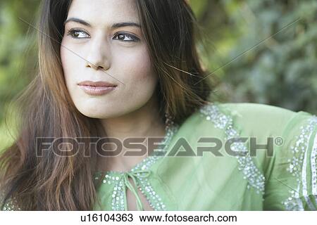 Stock Image - Close-up of a young woman looking away. Fotosearch