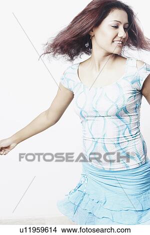 Close-up of a young woman standing with her arms outstretched View Large Photo Image Picture - Close-up of a young woman standing with her arms outstretched. Fotosearch