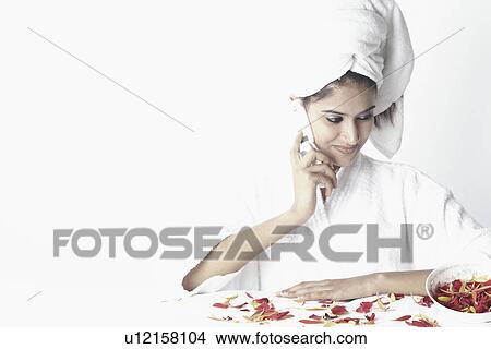 Picture - Close-up of a young woman talking on a mobile phone. Fotosearch