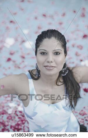 Stock Photo - High angle view of a young woman standing in a swimming pool. Fotosearch