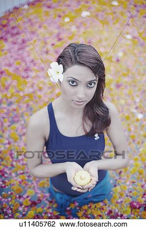 Portrait of a young woman holding a candle in a swimming pool View Large Photo Image Stock Image - Portrait of a young woman holding a candle in a swimming pool. Fotosearch