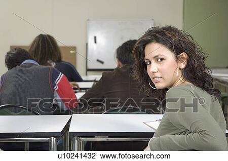 Portrait of a young woman in a classroom View Large Photo Image Stock Image - Portrait of a young woman in a classroom. Fotosearch