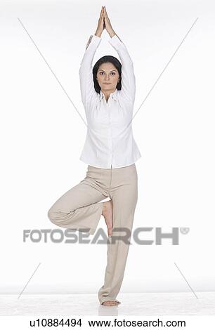 Picture - Portrait of a young woman standing on one leg. Fotosearch