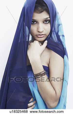 Stock Photo - Portrait of a young woman with her hand on her chin. Fotosearch