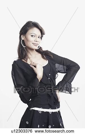Stock Photograph - Portrait of a young woman with her hand on her hip. Fotosearch