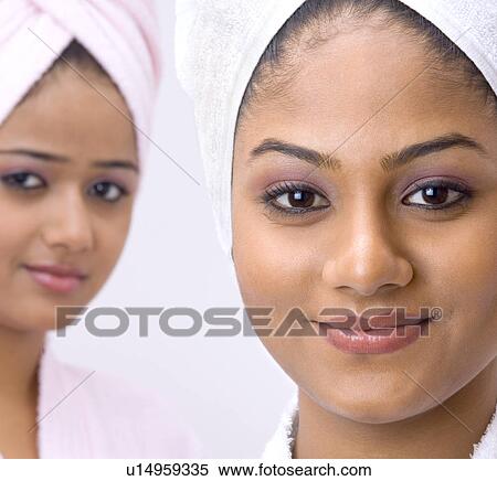 Stock Photography - Portrait of two young women wearing towels around their heads. Fotosearch
