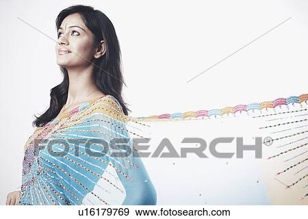 Side profile of a young woman looking up View Large Photo Image Stock Photo - Side profile of a young woman looking up. Fotosearch