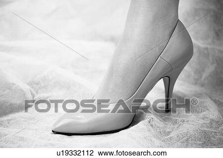 Stock Image - Woman's foot with high heel on, Close Up, Side View, Black and White. Fotosearch