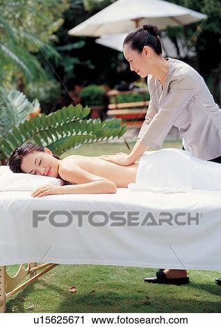 Stock Image - asian ethnicity, beauty spa female, beautifying, applying. Fotosearch