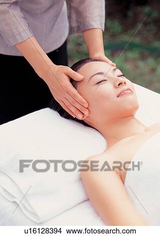 Picture - Asian woman getting massage. Fotosearch