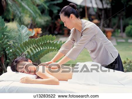 Asian woman getting massage View Large Photo Image Stock Image - Asian woman getting massage. Fotosearch